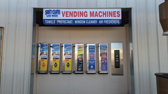 Vending machines providing cleaning supplies in the parking lot of all soft cloth locations.